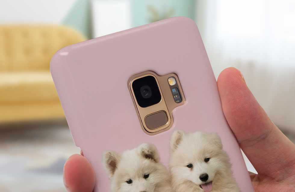 Hand holding pink mobile phone case 