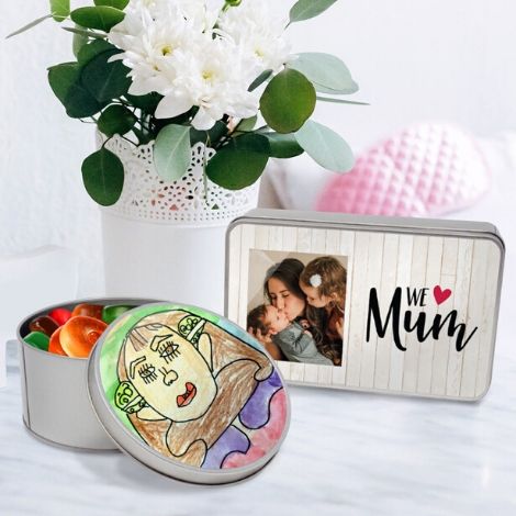 Table with flowers and two personalised gift tins 